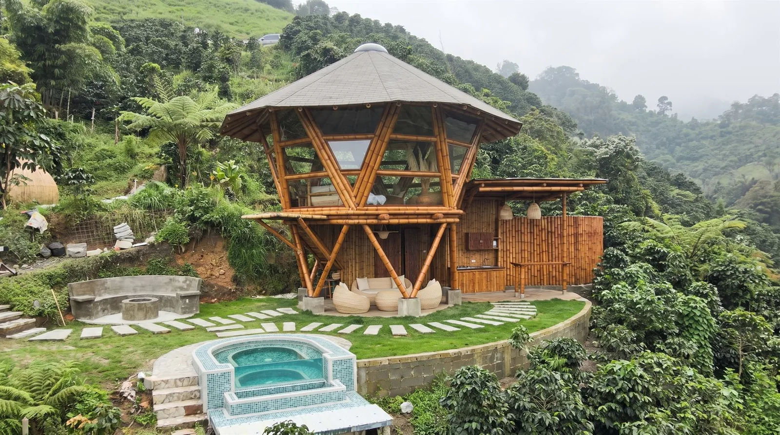 Vista aérea del glamping terminado, integrado a la ladera